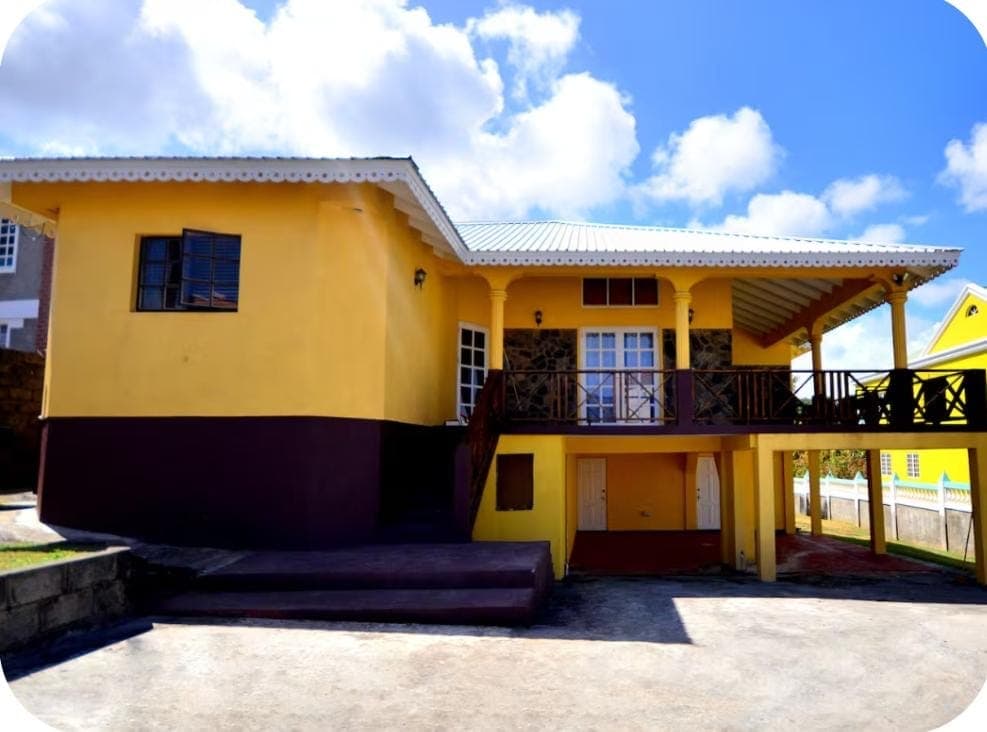 Front angle view showing the balcony and covered ground floor