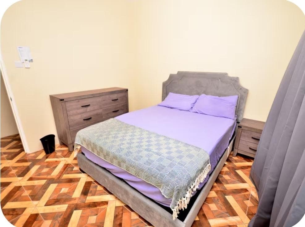 Full House - Cozy bedroom with lavender bedding and grey furniture