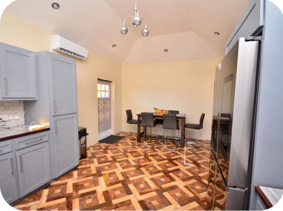 Shared Space - Kitchen and dining area with vaulted ceiling and air conditioning